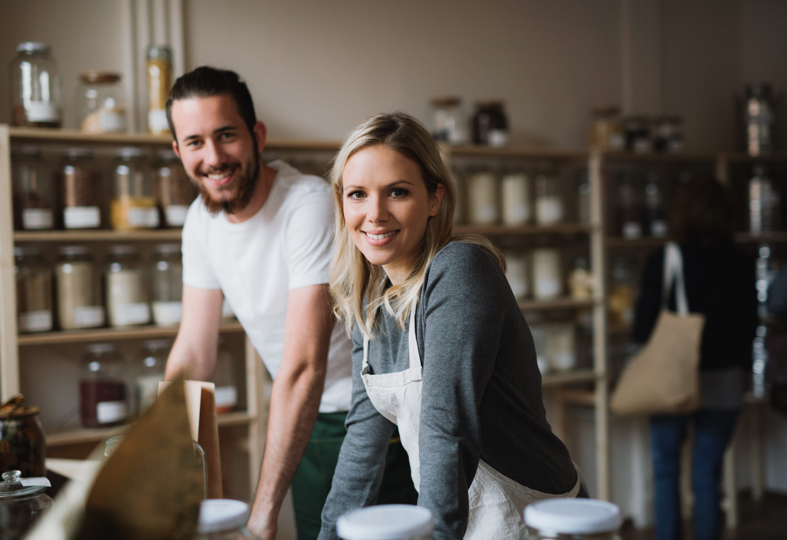 Business owners smiling in their shop